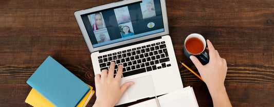 a pair of hands working typing on a computer and holding tea while on a video conference reposted by Pixel Profiles