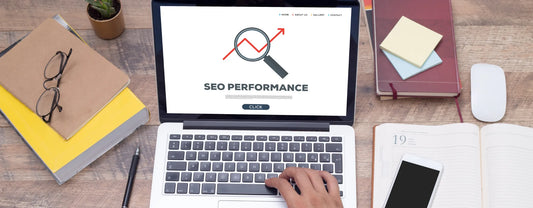 a hand on a laptop keyboard with the screen displaying the term "SEO performance" reposted by Pixel Profiles