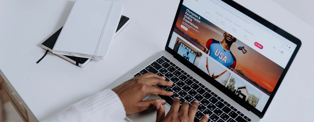 a pair of hands on a laptop's keyboard while looking at a website reposted by Pixel Profiles